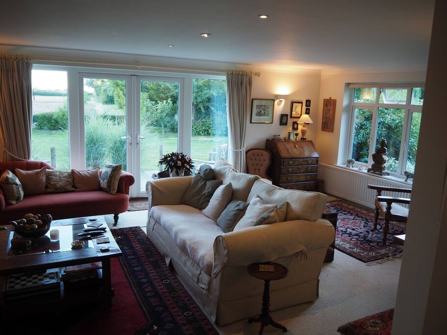 French windows and deck into the garden from sitting room