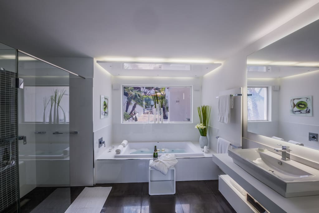 The bathroom with a whirlpool tub and shower is spacious and luxurious.