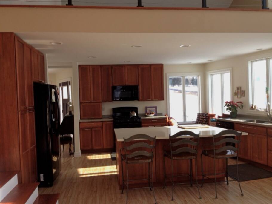 Window seat, large island, double-oven gas range, quiet dishwasher. The cook is never left out of the socializing!