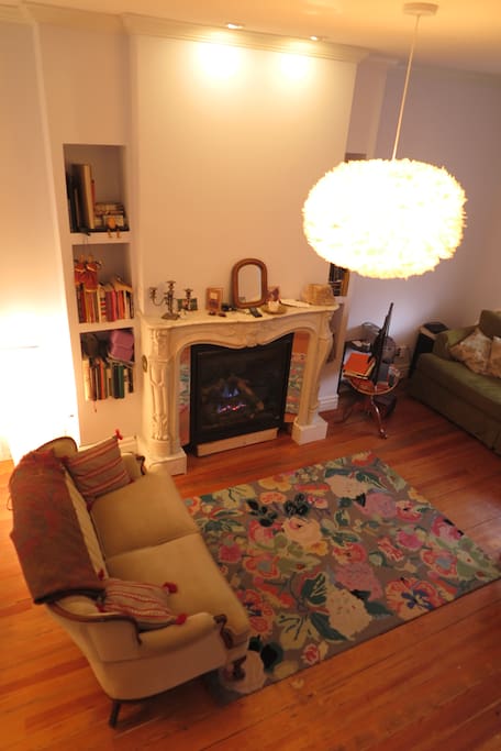 Inviting salon to enjoy a glass of wine by the fire and hand carved 19th century mantel.