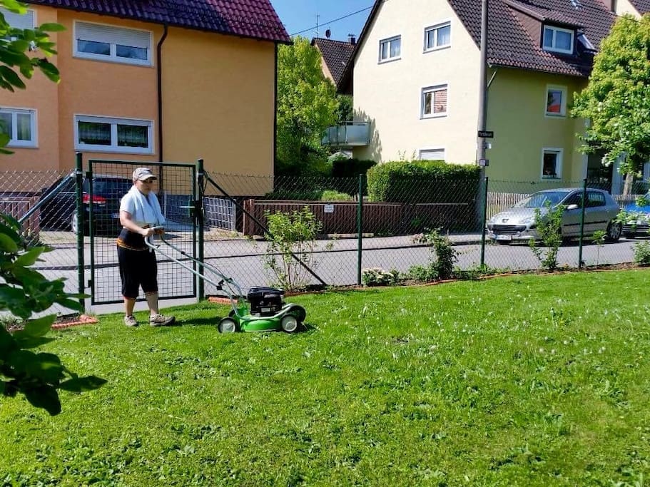 me, busy mowing the lawn in our 2nd garden, behind me Chrissi's apartment on the 1st floor.
