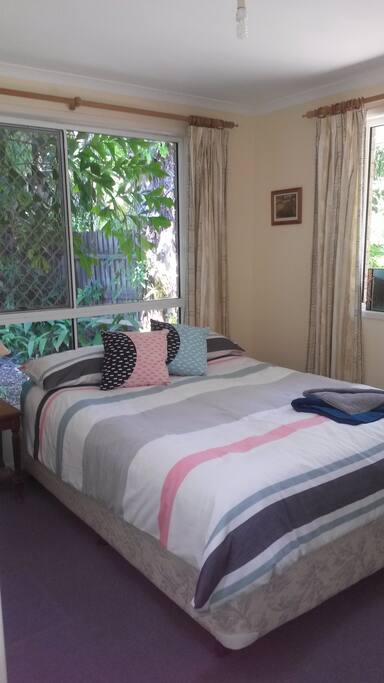 Queen size bed with innerspring for a good nights sleep surrounded by shady trees. Very private. This is Bedroom 1