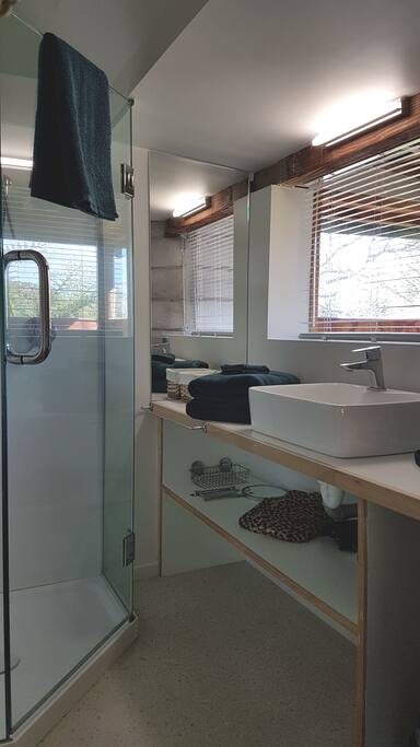 The ensuite is adjacent to and open to the bedroom. However there is another bathroom downstairs if more privacy is required.