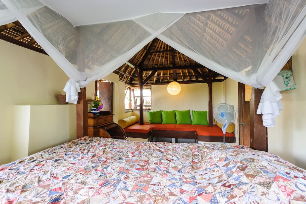 Orange built-in sofa bed suitable as extra bed for a child or reading, with ample space for storage below it.