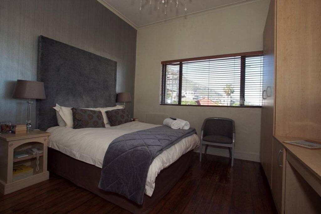 Spacious room with a desk to work on and a view of the sea