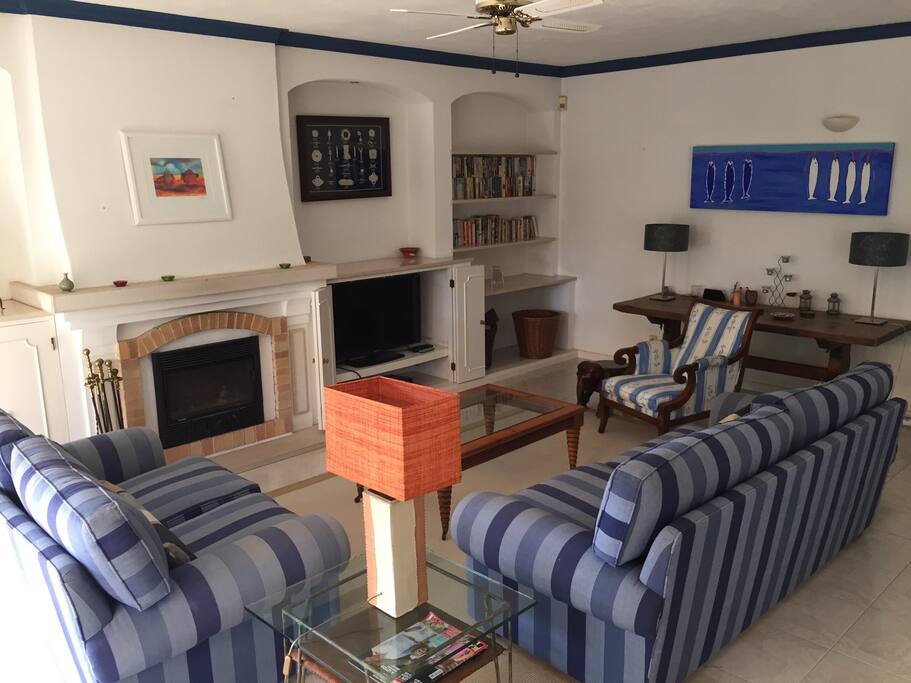 Living room with Tv / cable, fireplace and and access to outdoor patio