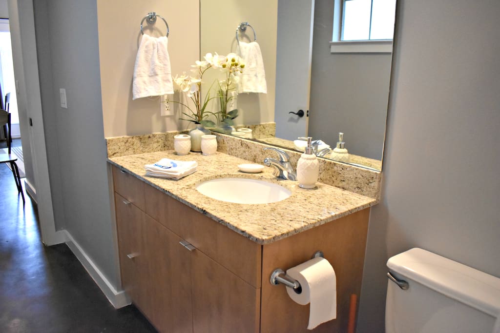 Granite counter tops in well lit bathroom
