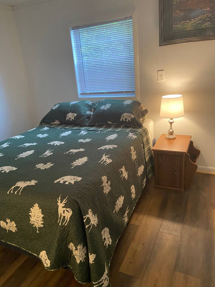 Green Bedroom- The second bedroom has a new firm queen size mattress. A closet and dresser for your belongings are here as well. 