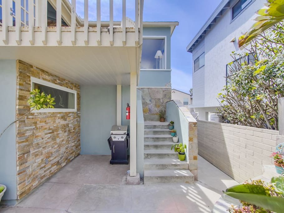 Stairs go up to the front door entrance and additional patio, great for grilling