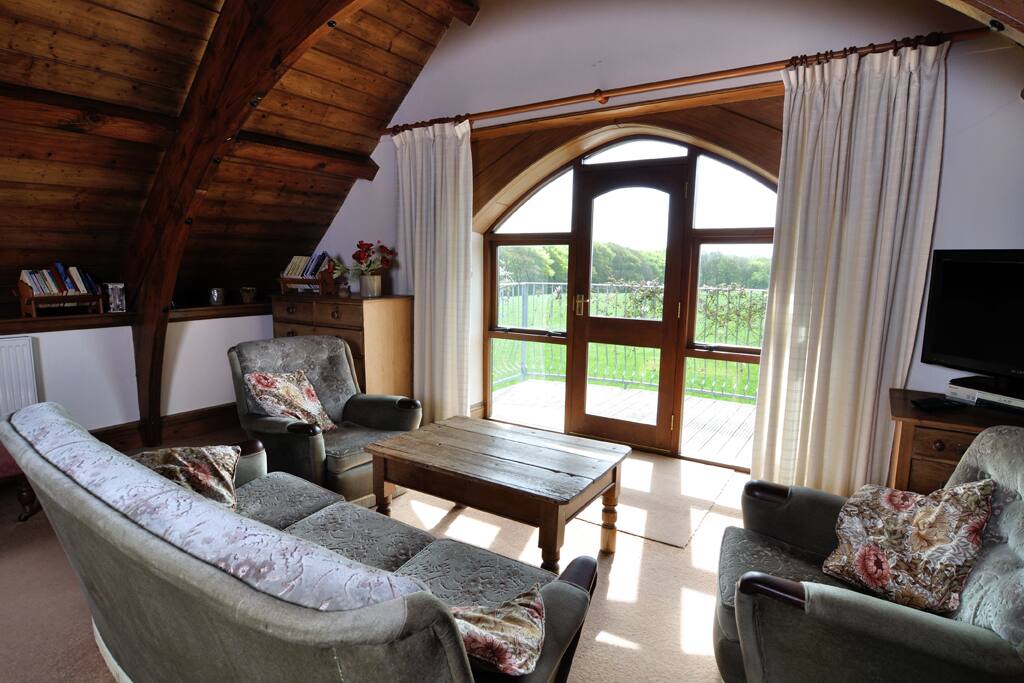 Relax in our cosy sitting room, overlooking beautiful green fields.