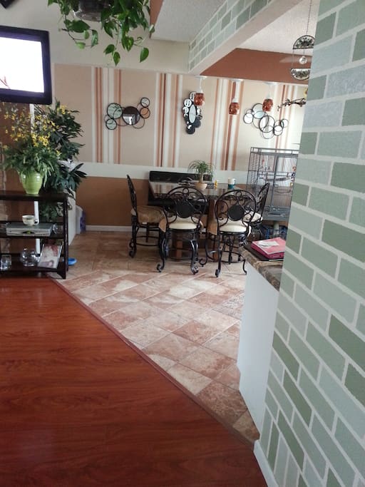 Dining room area. New furniture, modern remodeled floors, doors, windows, and lighting.