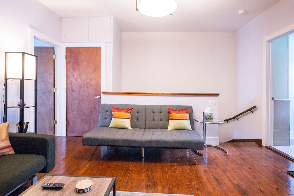 Up one flight of stairs, you will find a spacious, open LR/DR room with new floors and furnishings. Large coat closet is next to sofa.