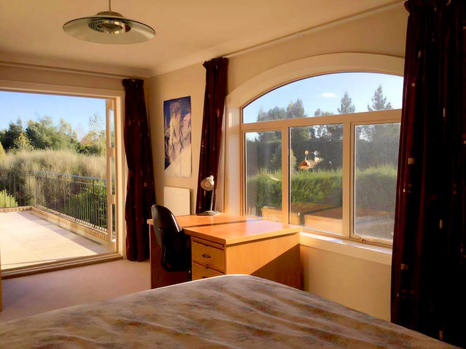 The bedroom is on the second level, with a balcony that overlooks the main garden.