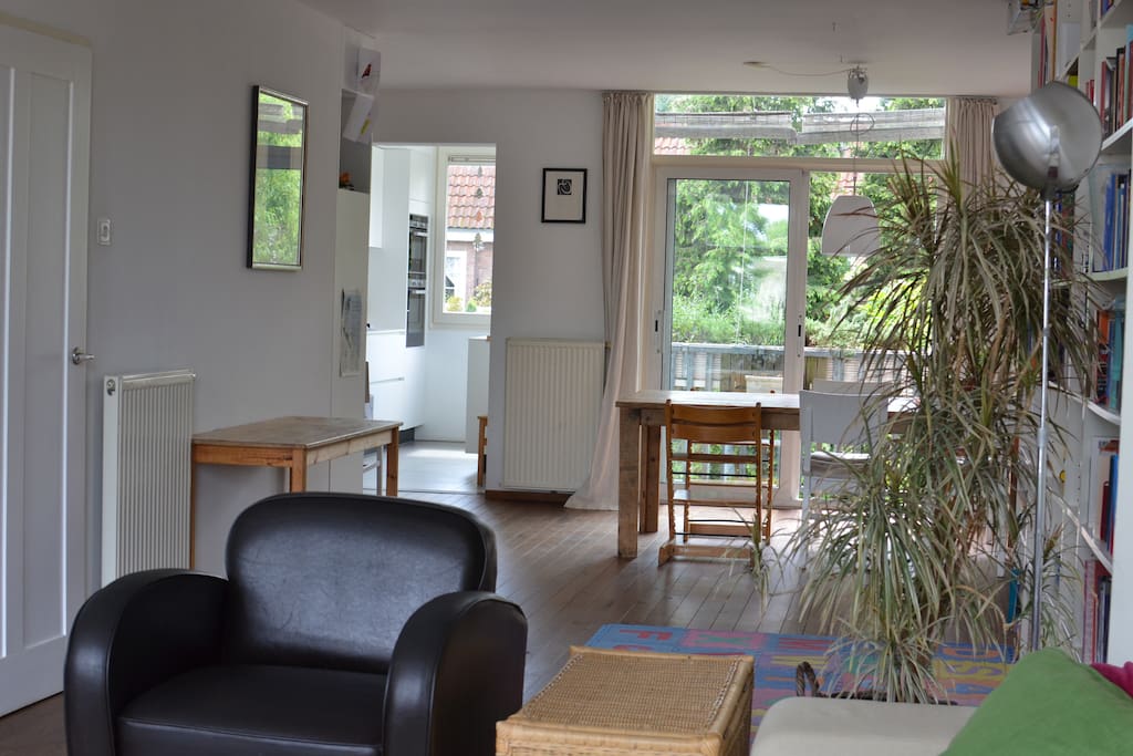 Living room with view to the back including kitchen and dining table
