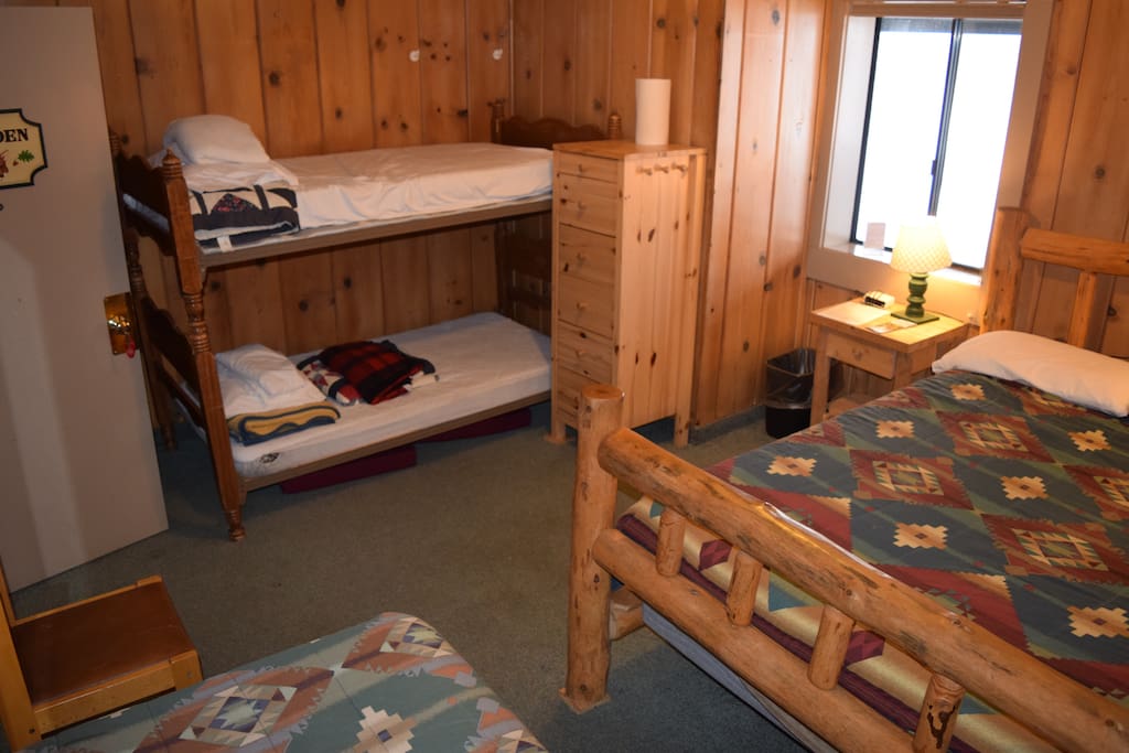 Rustic Lodge room 8 with queen bed, twin bed and bunk beds (bring sleeping bags for bunk beds), shared bathroom down hallway, separate for men and women.