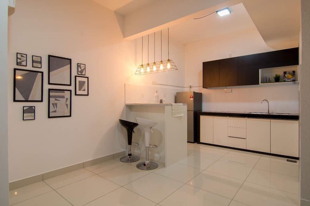 dry kitchen with wash basin. island table and high stool