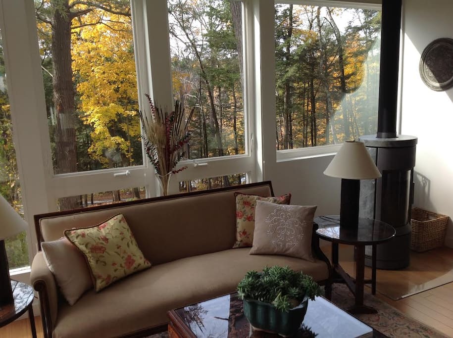 Windows with views of wildlife, trees, boulders and Housatonic River.