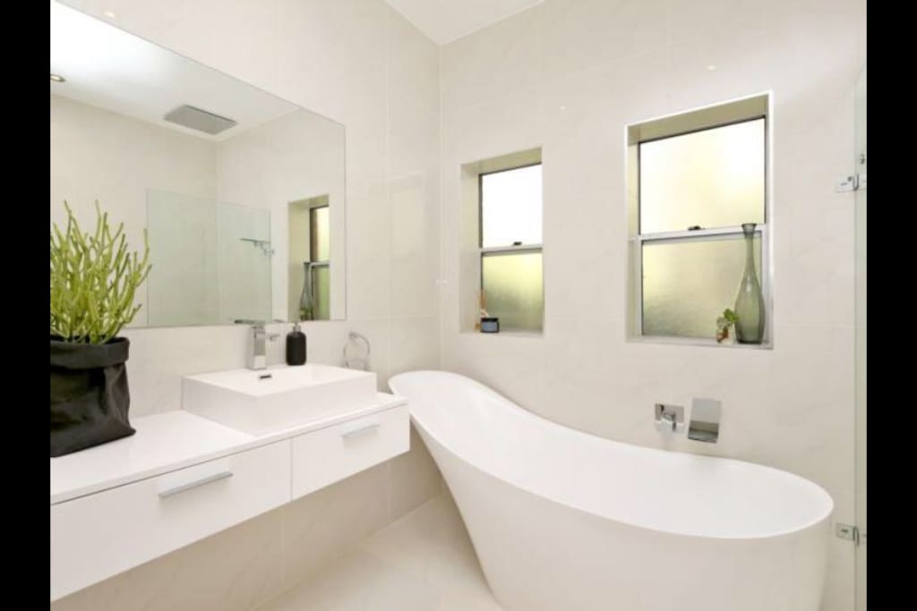 Beautiful bathroom with monsoon shower and bath