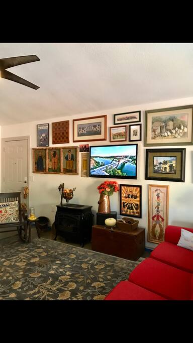 Living area with gas logs and TV on the wall.