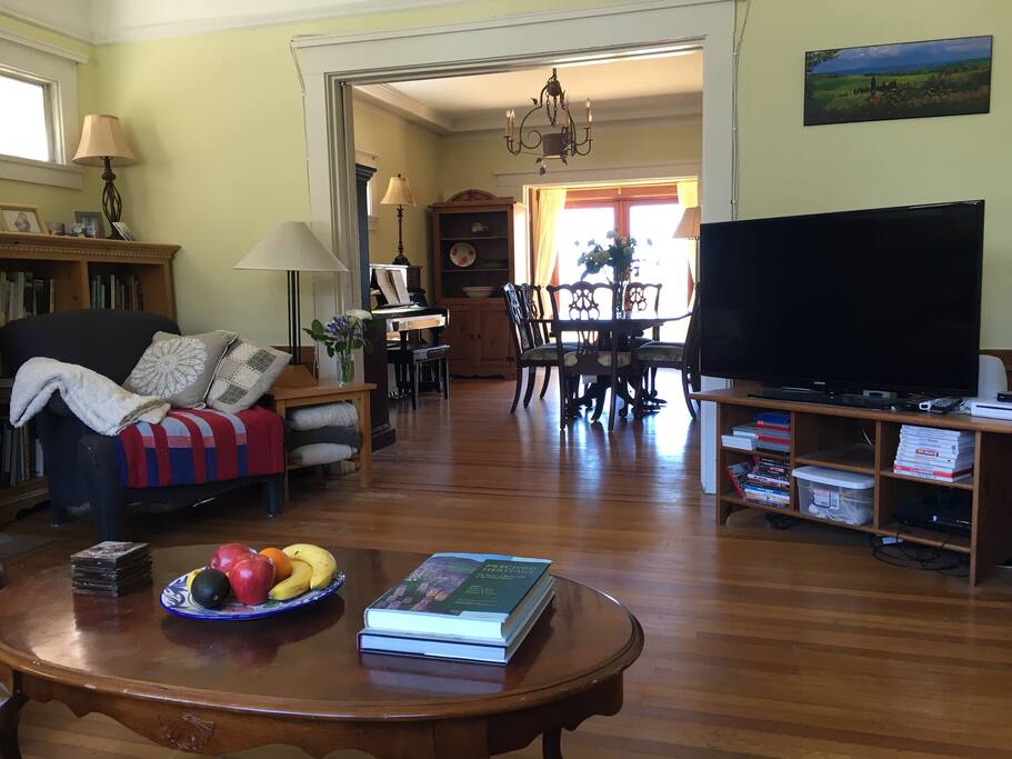 Welcoming double reception room with original hardwood floors: The living room with a view to the dining room