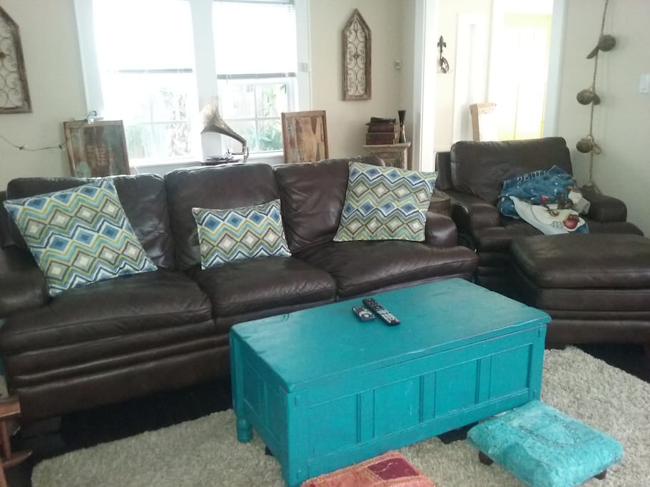 Living room space with large leather couch.
