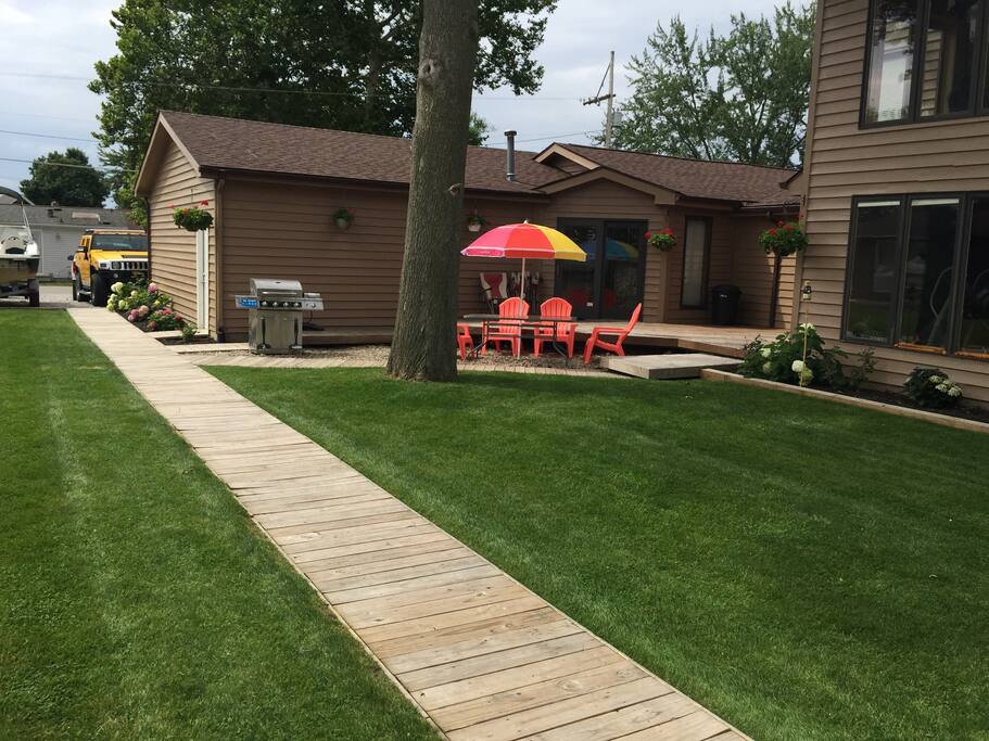 View of the rear deck of the single story Condo with a partial view of the two story owners home attached to the right