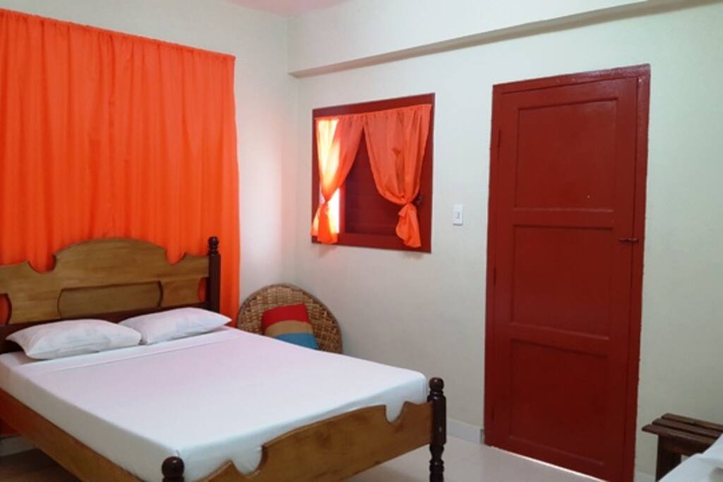 The bedroom with a door to the balcony