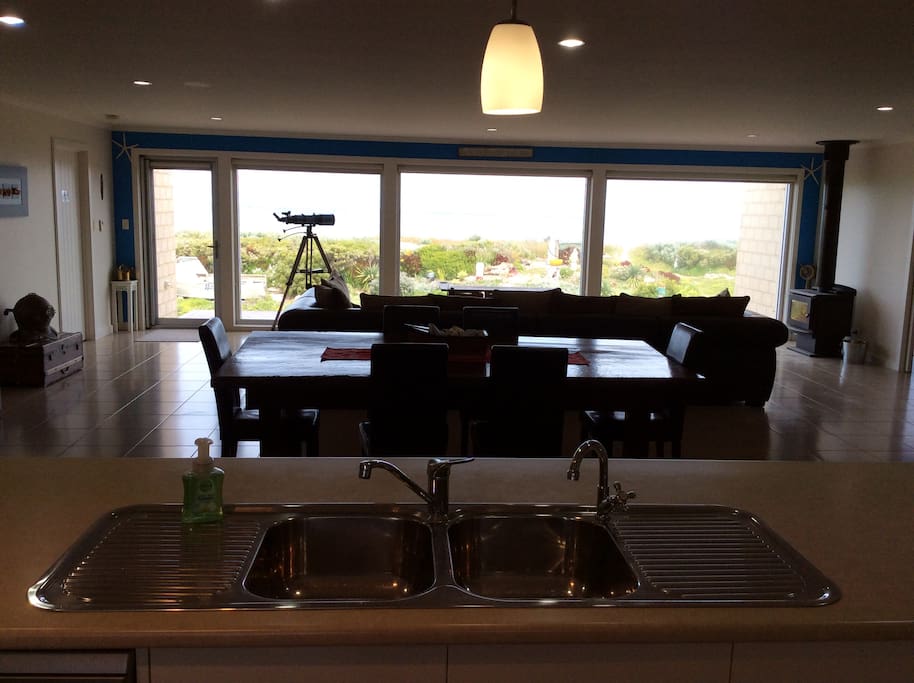 View front kitchen area, across dining to lounge area.