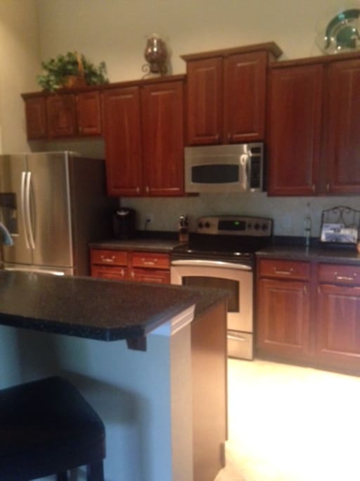 Spacious full kitchen & breakfast bar.