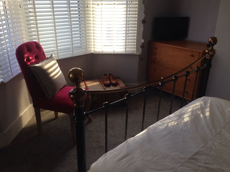 Feature chair & antique chest, sunny bay window with blinds, tv
