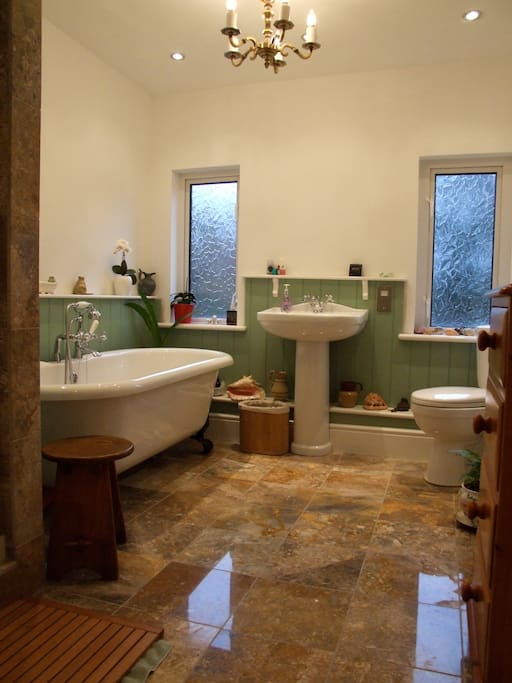 A modern fully equipped bathroom which includes a shower cubicle, and luxury underfloor heating