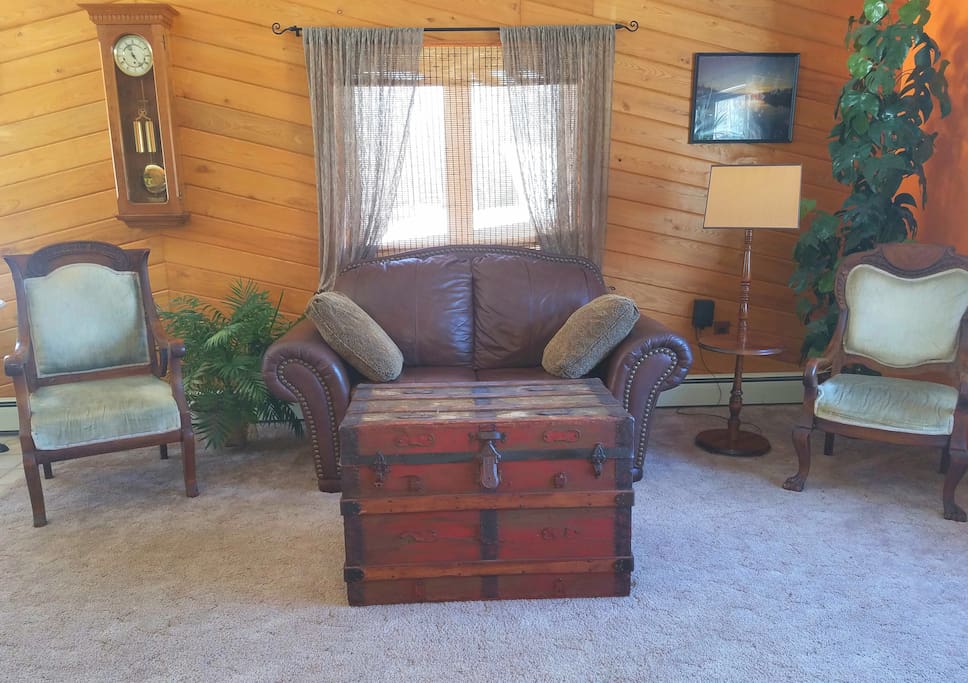Sunny living room with rustic chest. (Open the chest to find games!)