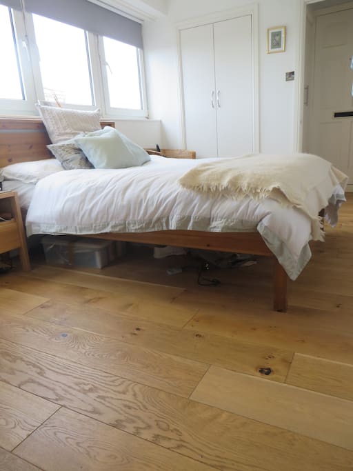Separate bedroom with chest of drawers, fitted wardrobes and bedside table.