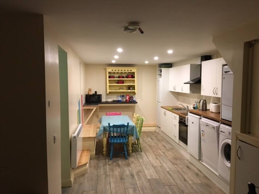 This is our spacious kitchen full equipped with washer, dryer hob & over.
