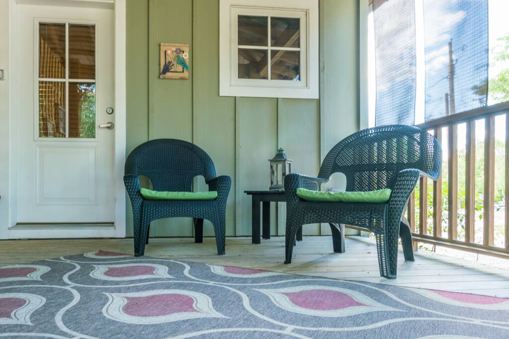 A covered porch protects you from the sun & rain while you enjoy the outdoors!