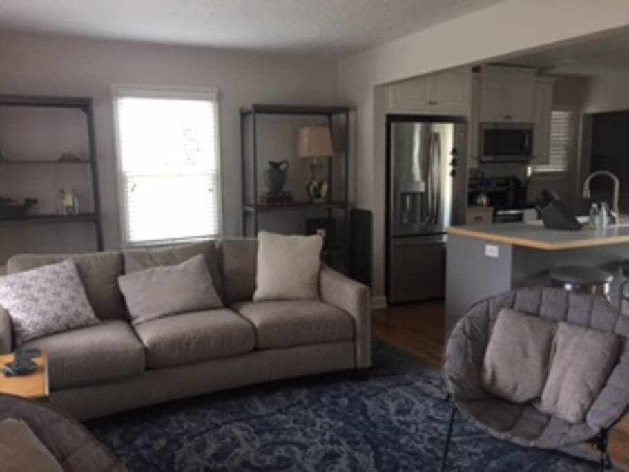 Living room area open to the kitchen and dining.