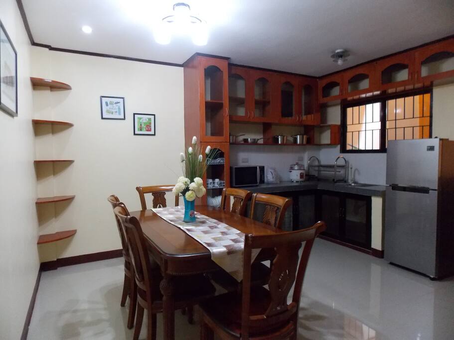 Big Dining room with Microwave oven, Frigidaire, Induction Cooker, 6 seat Dining table, Utensils & Cooking ware, Plates etc.