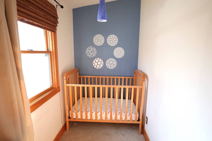 Nursery with full size crib.