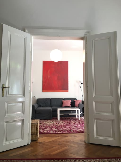 Living room seen through large French doors from the master bedroom