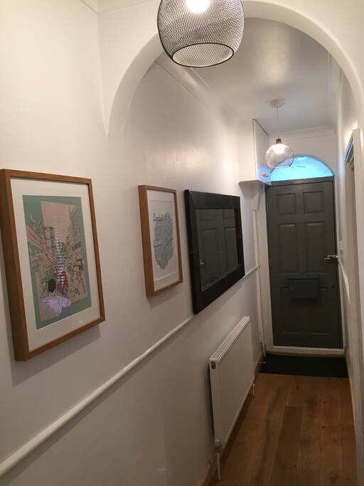 Hall with large mirror and pictures.