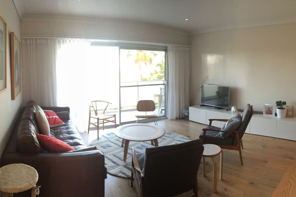 Living area with sliding doors opening up to large balcony
