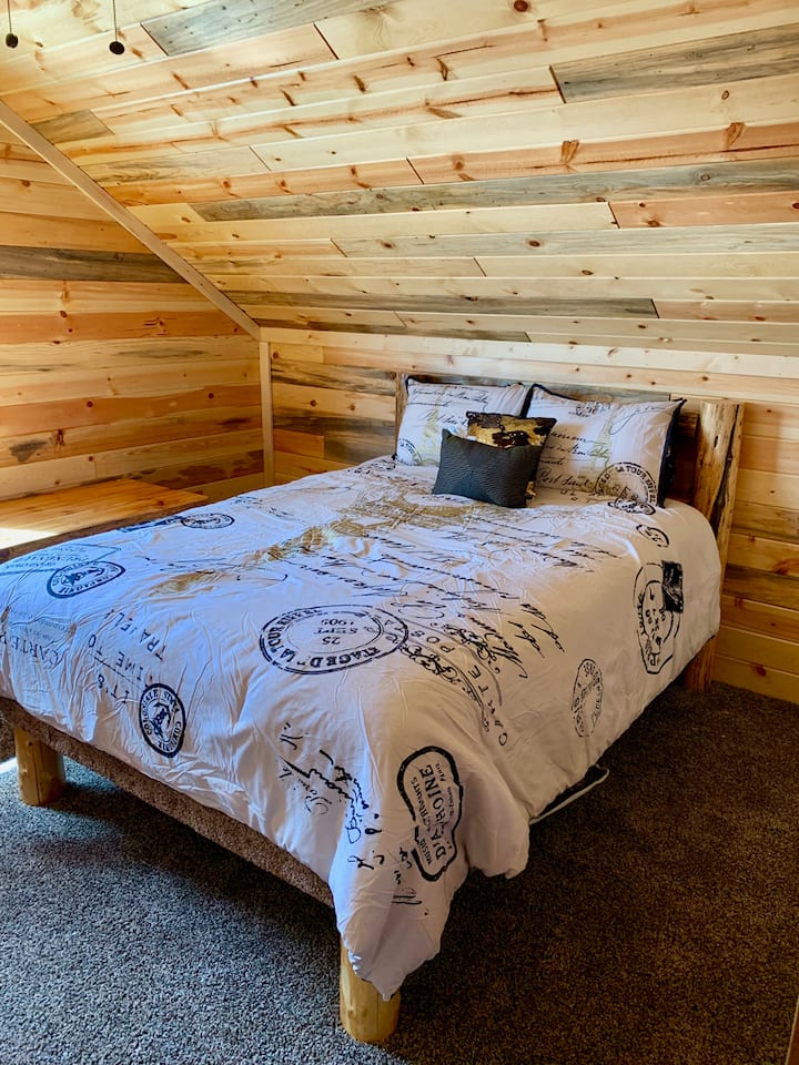 Bedroom #2 Upstairs with a queen-sized log bed.