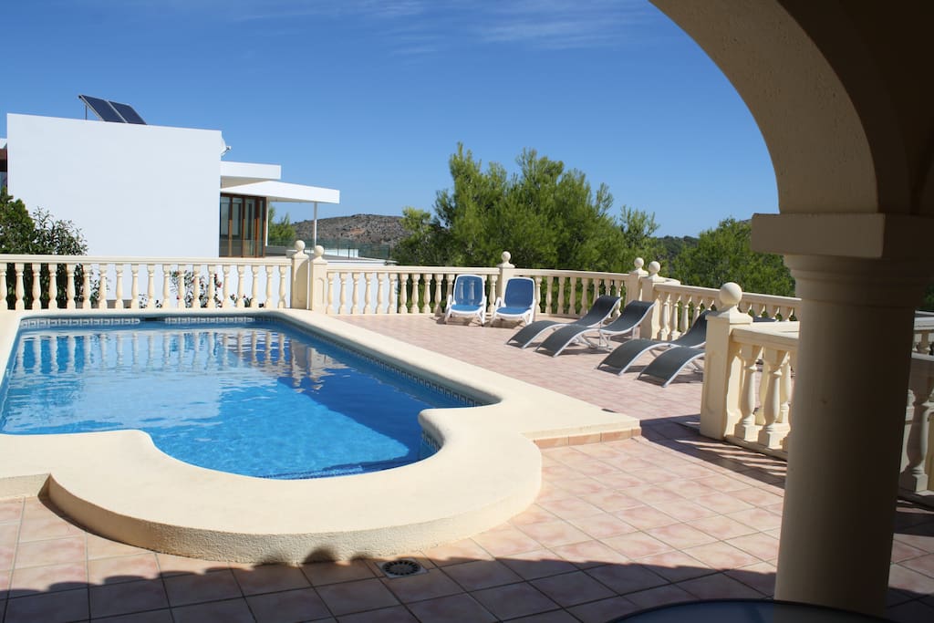 Pool with lots of terracing and loungers supplied.