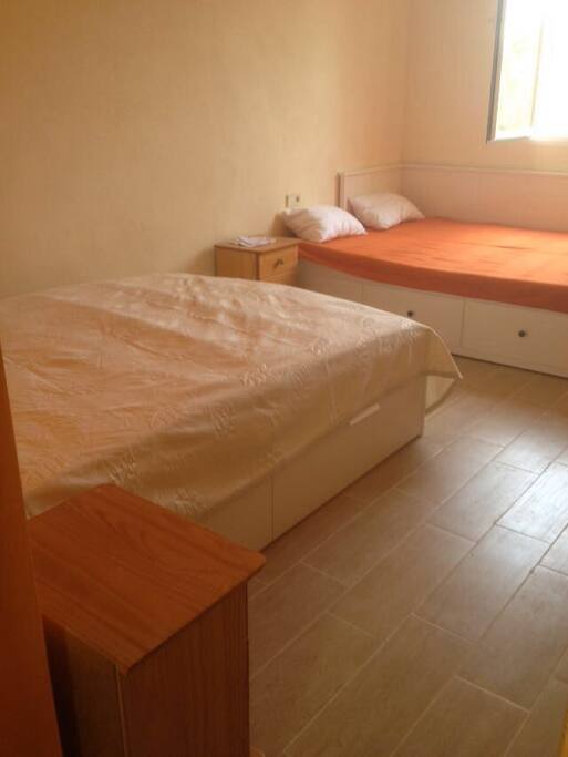 The orange bedroom with two double beds, ideal for a family or two couples