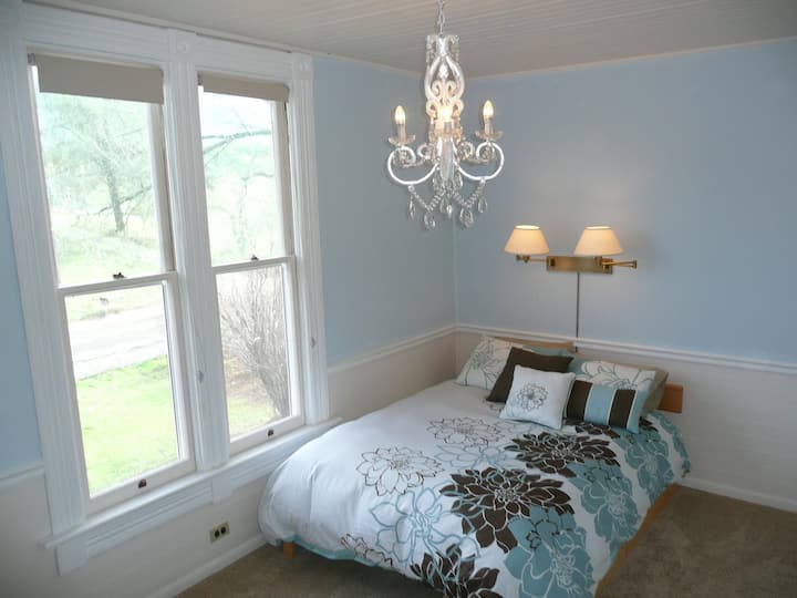 Our upstairs "Sky View" room has a double bed with cozy comforters and soft pillows.