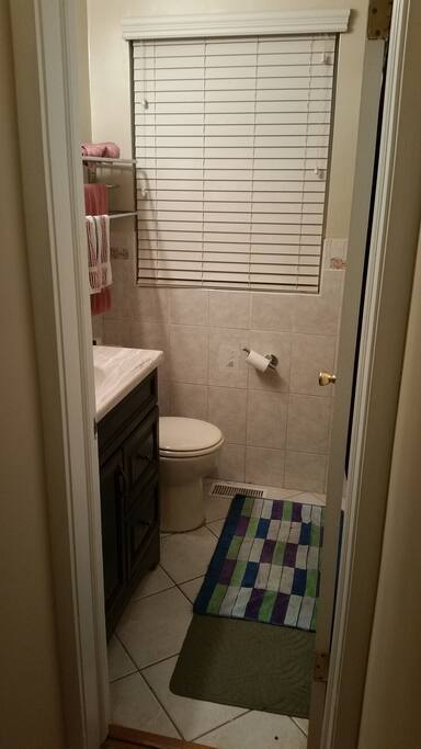 Full bathroom with tiled walk-in shower. Might be shared