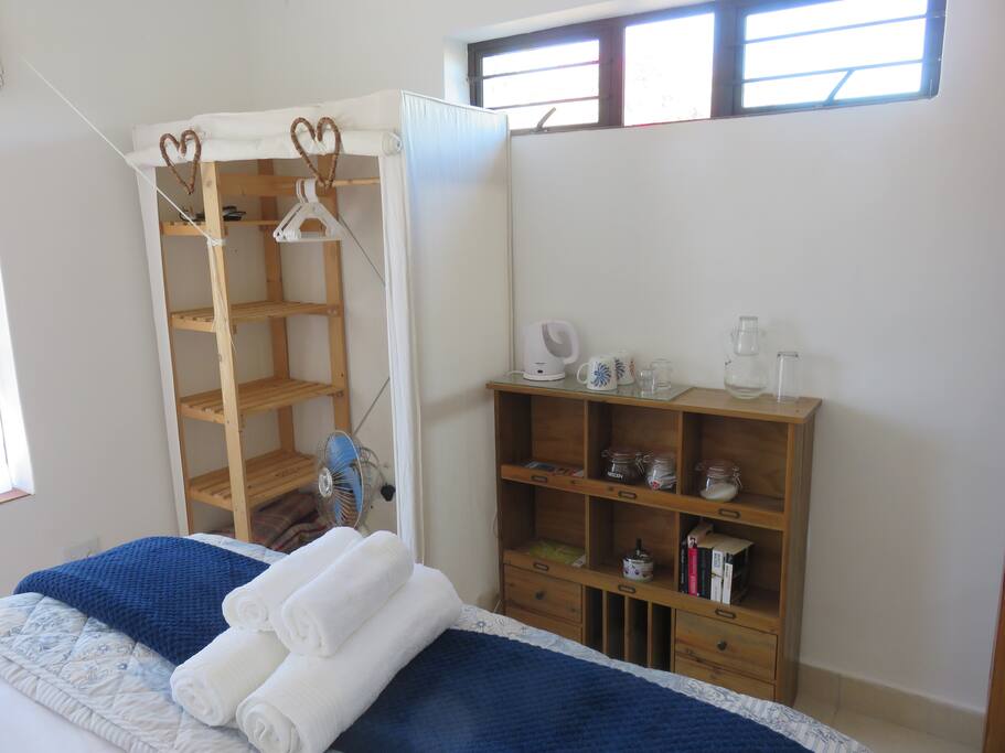 Hanging space and shelves. Tea & Coffee station in the room.