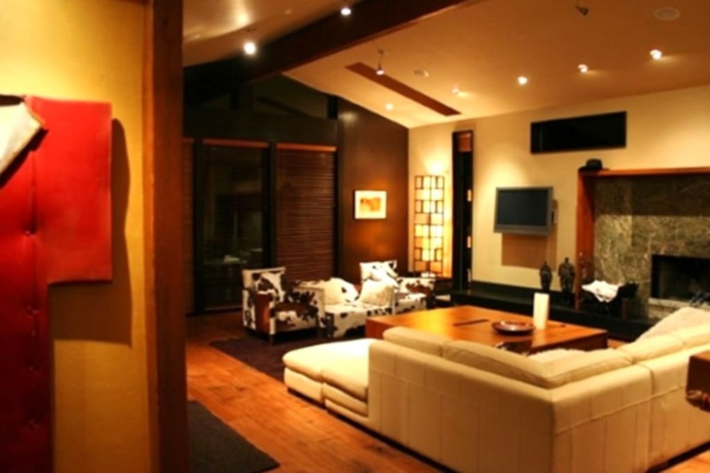 Living room with wood fireplace and designer furnishings.