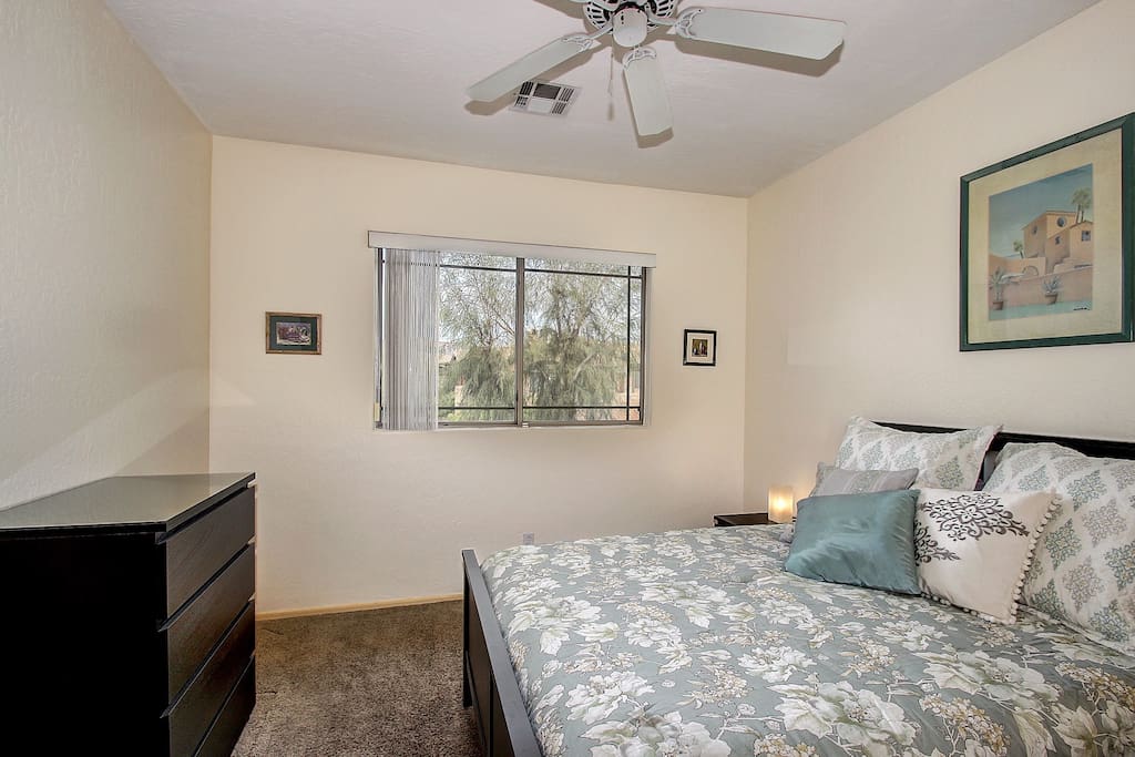 Queen bed with large closet, dresser and overhead fan