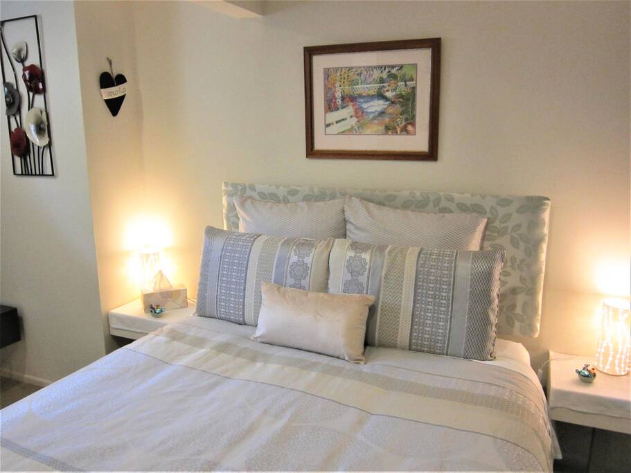 A quiet room with a very comfortable queen bed, memory foam pillows, pure cotton sheets and thick new carpets. Bathroom is to the left of shot, lounge to the right.